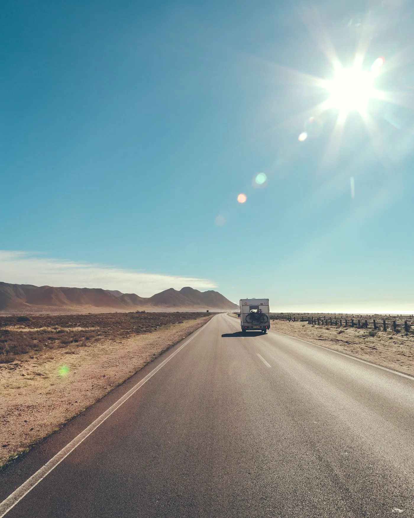 Van driving on an open road, recharging stop ahead